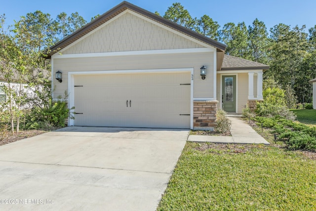 view of front of home with concrete driveway, an attached garage, roof with shingles, and stone siding