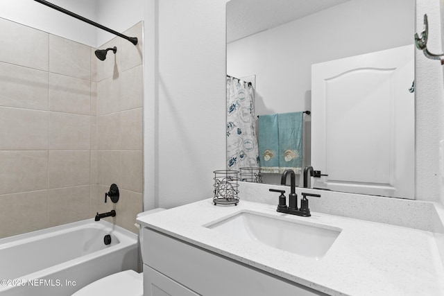 full bathroom with vanity, toilet, and shower / tub combo with curtain