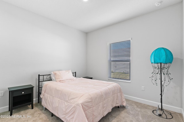 bedroom with carpet and baseboards