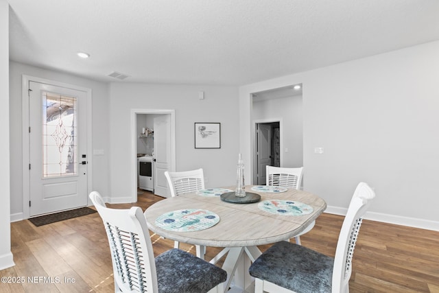 dining space featuring wood finished floors, baseboards, and recessed lighting