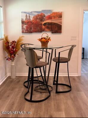 6845 Cherbourg Ave S, Jacksonville, FL 32205 - dining space with dark wood-style floors and baseboards