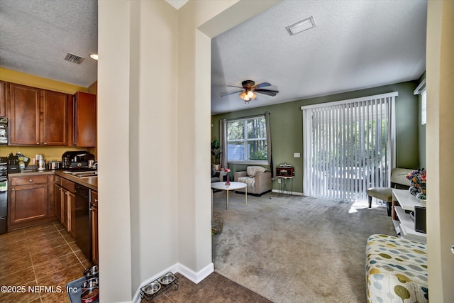 8672 Ribbon Falls Ln, Jacksonville, FL 32244 - living room with a textured ceiling, a ceiling fan, baseboards, dark tile patterned flooring, and dark colored carpet