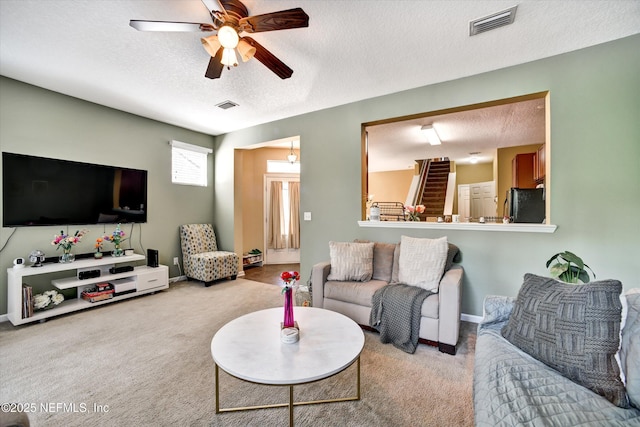 8672 Ribbon Falls Ln, Jacksonville, FL 32244 - carpeted living area featuring a ceiling fan, a textured ceiling, and baseboards