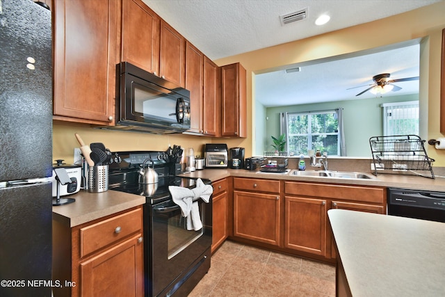 8672 Ribbon Falls Ln, Jacksonville, FL 32244 - kitchen featuring black appliances, a sink, light tile patterned floors, brown cabinets, and a ceiling fan