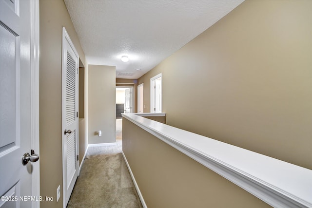 8672 Ribbon Falls Ln, Jacksonville, FL 32244 - hall featuring light carpet, baseboards, and a textured ceiling