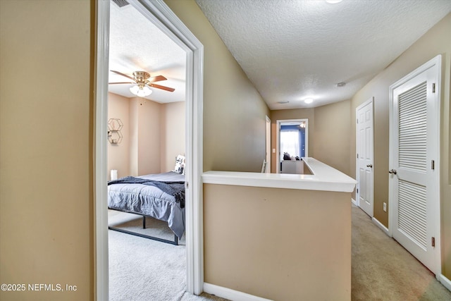 8672 Ribbon Falls Ln, Jacksonville, FL 32244 - hall with light carpet, baseboards, and a textured ceiling