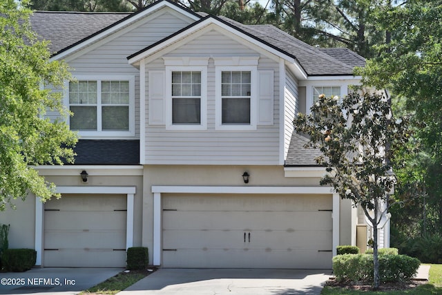 8672 Ribbon Falls Ln, Jacksonville, FL 32244 - view of front of house featuring roof with shingles, driveway, and a garage