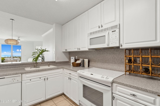 4776 Amelia Island Pkwy Unit 74, Fernandina Beach, FL 32034 - kitchen with white appliances, a sink, tasteful backsplash, and white cabinets