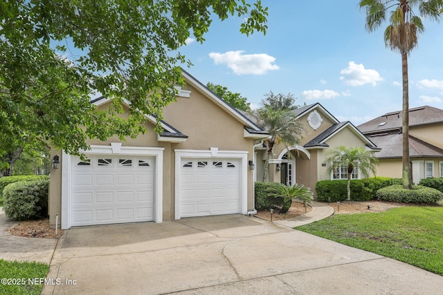 2260 Harbor Lake Dr, Fleming Island, FL 32003 - view of front of home featuring driveway, a garage, stucco siding, and a front lawn