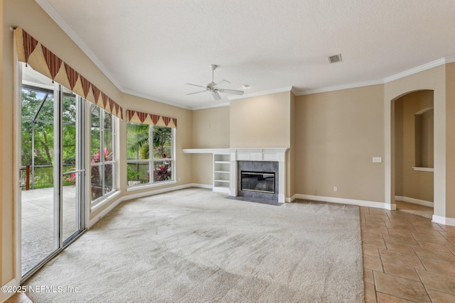 2260 Harbor Lake Dr, Fleming Island, FL 32003 - unfurnished living room featuring ceiling fan, crown molding, arched walkways, a high end fireplace, and baseboards
