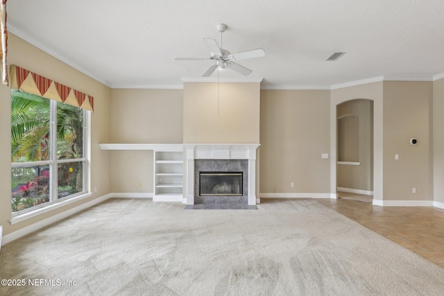 2260 Harbor Lake Dr, Fleming Island, FL 32003 - unfurnished living room featuring a ceiling fan, baseboards, crown molding, a fireplace, and arched walkways