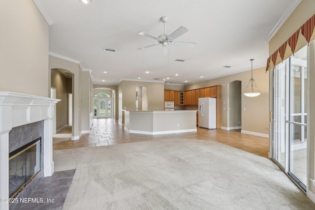 2260 Harbor Lake Dr, Fleming Island, FL 32003 - unfurnished living room with arched walkways, light tile patterned floors, ornamental molding, a ceiling fan, and recessed lighting