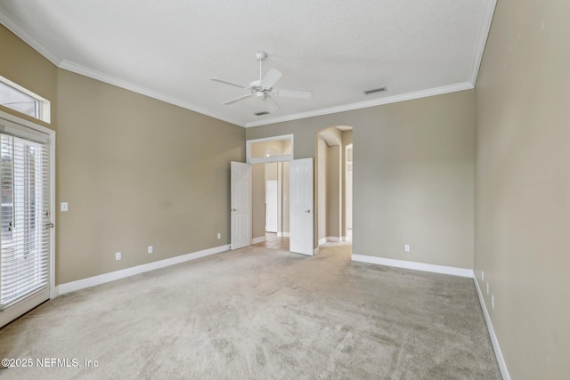 2260 Harbor Lake Dr, Fleming Island, FL 32003 - unfurnished bedroom featuring arched walkways, crown molding, carpet floors, baseboards, and a ceiling fan