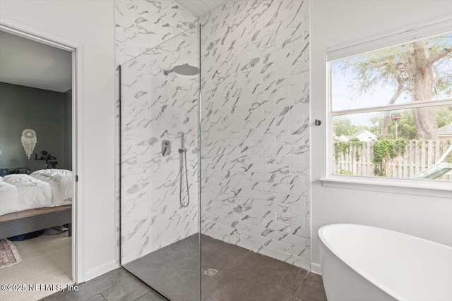 ensuite bathroom featuring a freestanding bath, a walk in shower, and plenty of natural light