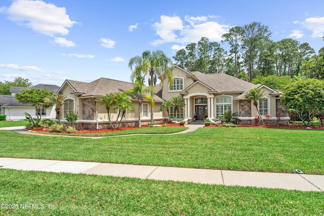 389 Summerset Dr, Saint Johns, FL 32259 - view of front of house with stucco siding, stone siding, and a front lawn
