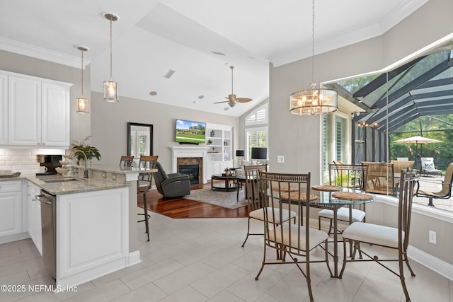 389 Summerset Dr, Saint Johns, FL 32259 - dining area featuring a fireplace, ceiling fan, built in features, baseboards, and light tile patterned flooring