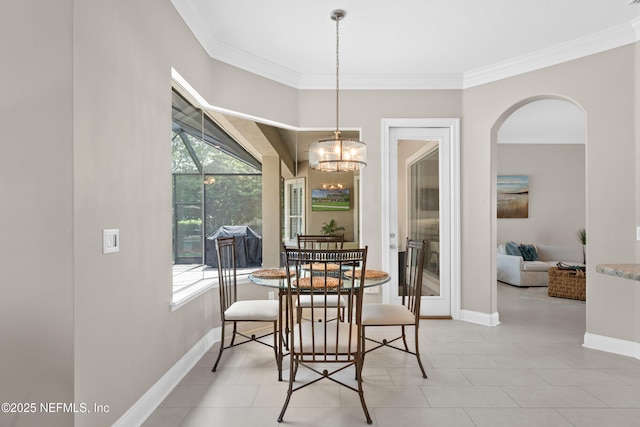 389 Summerset Dr, Saint Johns, FL 32259 - dining room with crown molding, arched walkways, baseboards, a chandelier, and light tile patterned flooring