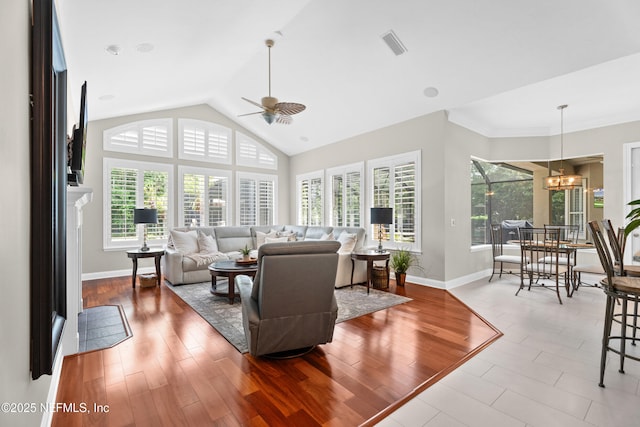 389 Summerset Dr, Saint Johns, FL 32259 - living room with ceiling fan, baseboards, lofted ceiling, a chandelier, and wood finished floors