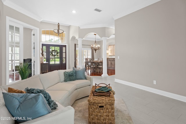 389 Summerset Dr, Saint Johns, FL 32259 - tiled living area with decorative columns, ornamental molding, arched walkways, a chandelier, and baseboards