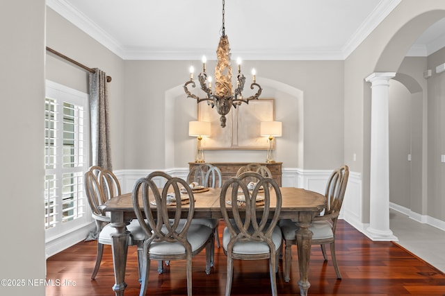 389 Summerset Dr, Saint Johns, FL 32259 - dining room with arched walkways, wood finished floors, crown molding, a chandelier, and a wainscoted wall
