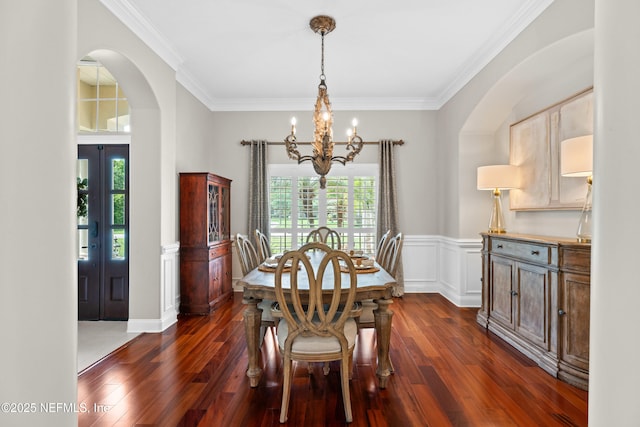 389 Summerset Dr, Saint Johns, FL 32259 - dining area with a chandelier, arched walkways, dark wood finished floors, crown molding, and a wainscoted wall