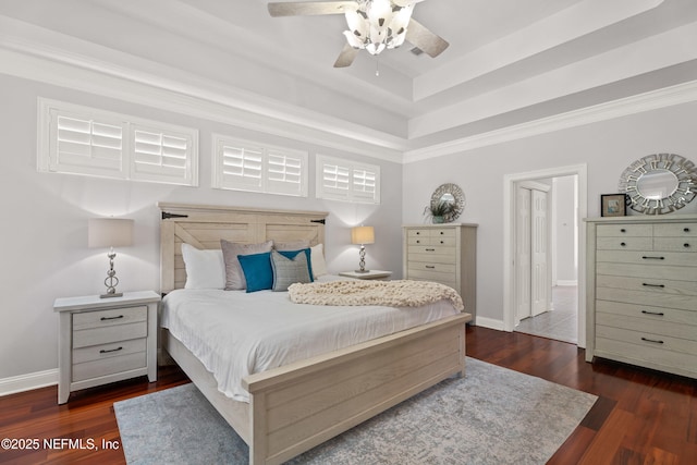 389 Summerset Dr, Saint Johns, FL 32259 - bedroom featuring dark wood-style flooring, baseboards, a tray ceiling, ornamental molding, and a ceiling fan
