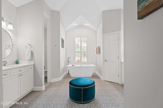 389 Summerset Dr, Saint Johns, FL 32259 - full bathroom featuring a freestanding tub, vanity, lofted ceiling, recessed lighting, and baseboards
