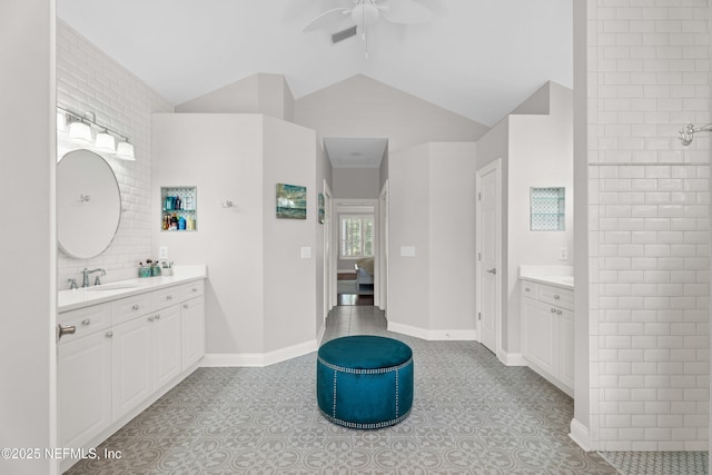 389 Summerset Dr, Saint Johns, FL 32259 - ensuite bathroom with two vanities, ceiling fan, and vaulted ceiling