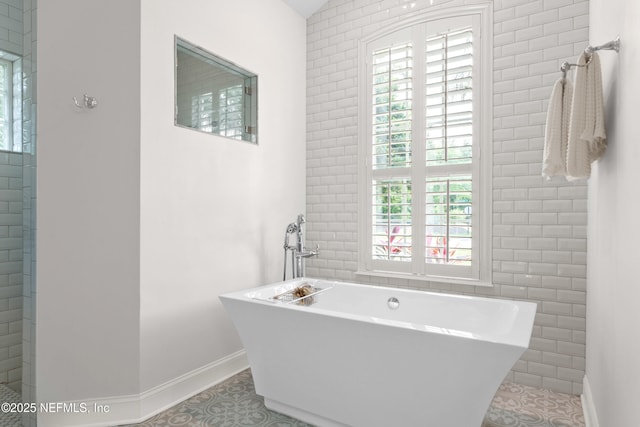 389 Summerset Dr, Saint Johns, FL 32259 - bathroom with tile patterned flooring, baseboards, and a freestanding bath