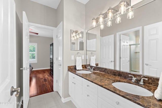389 Summerset Dr, Saint Johns, FL 32259 - bathroom featuring tile patterned flooring, double vanity, a shower with door, and baseboards