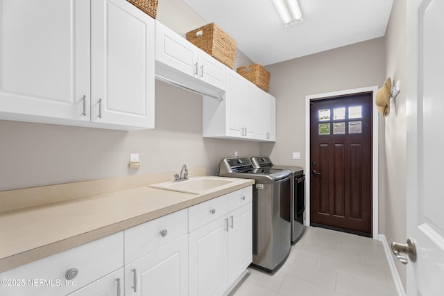 389 Summerset Dr, Saint Johns, FL 32259 - laundry area with cabinet space, separate washer and dryer, light tile patterned floors, and baseboards