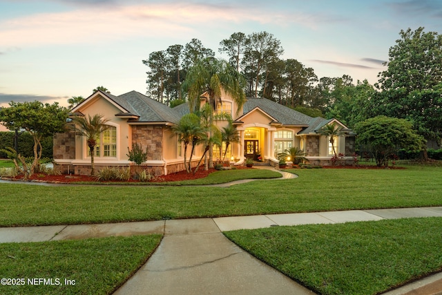 389 Summerset Dr, Saint Johns, FL 32259 - view of front of house featuring stone siding, a front yard, and stucco siding