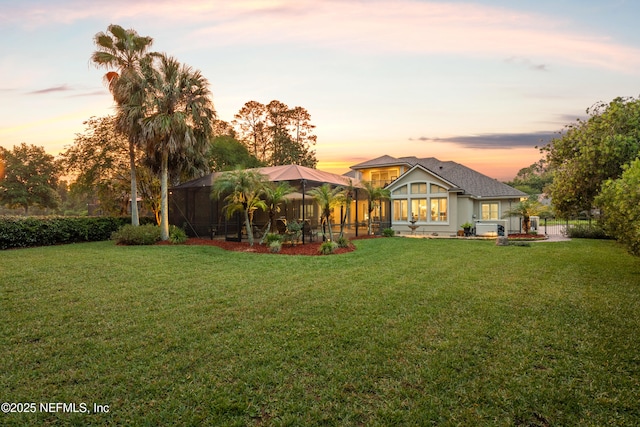 389 Summerset Dr, Saint Johns, FL 32259 - back of house at dusk with a yard and glass enclosure