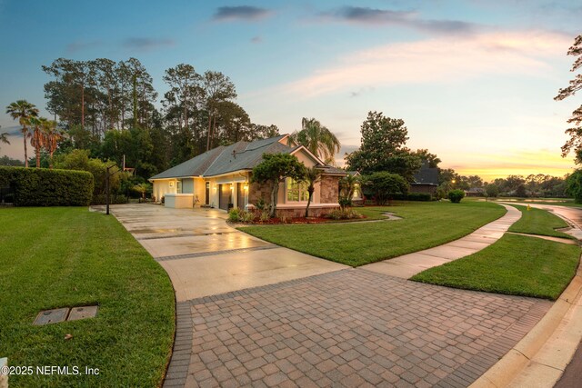 389 Summerset Dr, Saint Johns, FL 32259 - view of front of house with driveway, a yard, and stone siding