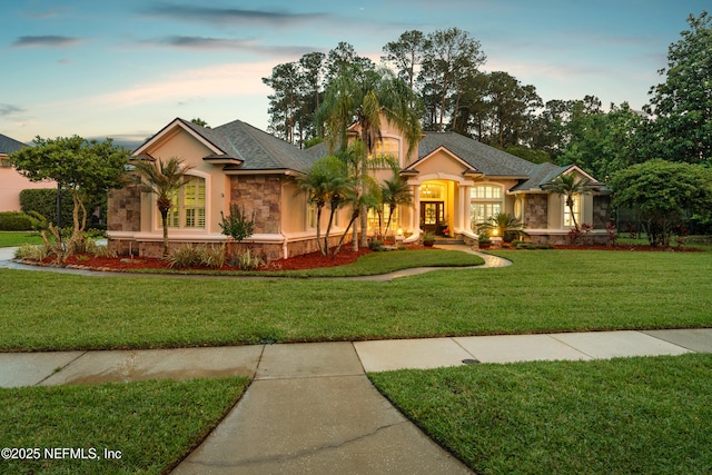 389 Summerset Dr, Saint Johns, FL 32259 - view of front facade featuring stone siding, stucco siding, and a yard