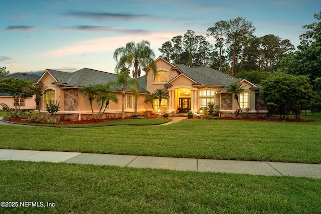 389 Summerset Dr, Saint Johns, FL 32259 - view of front facade featuring stucco siding, a lawn, and stone siding