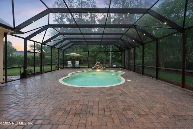 389 Summerset Dr, Saint Johns, FL 32259 - pool at dusk featuring a patio area, an outdoor pool, and a lanai