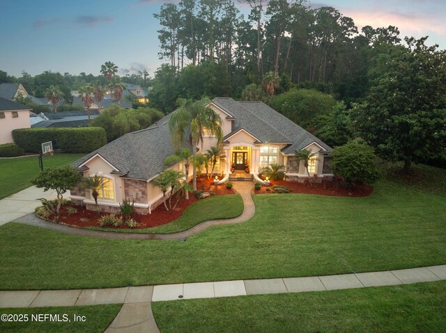 389 Summerset Dr, Saint Johns, FL 32259 - view of front of home featuring a front yard, stucco siding, and a shingled roof