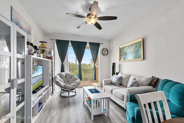 7801 Point Meadows Dr Unit 2302, Jacksonville, FL 32256 - living area featuring ceiling fan, wood finished floors, and a textured ceiling