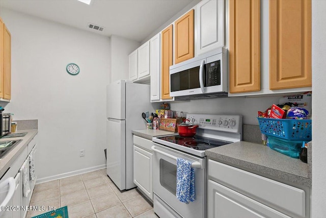 7801 Point Meadows Dr Unit 2302, Jacksonville, FL 32256 - kitchen with white appliances, light tile patterned floors, and baseboards