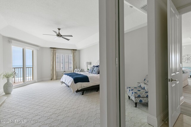 932 1st St N Unit 902, Jacksonville Beach, FL 32250 - bedroom featuring light colored carpet, access to exterior, baseboards, ceiling fan, and a textured ceiling