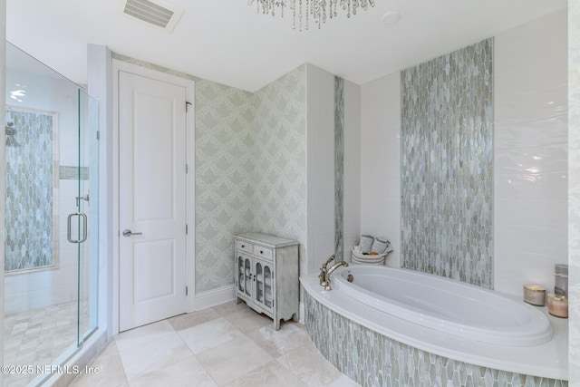 932 1st St N Unit 902, Jacksonville Beach, FL 32250 - bathroom with a stall shower, a garden tub, baseboards, and wallpapered walls