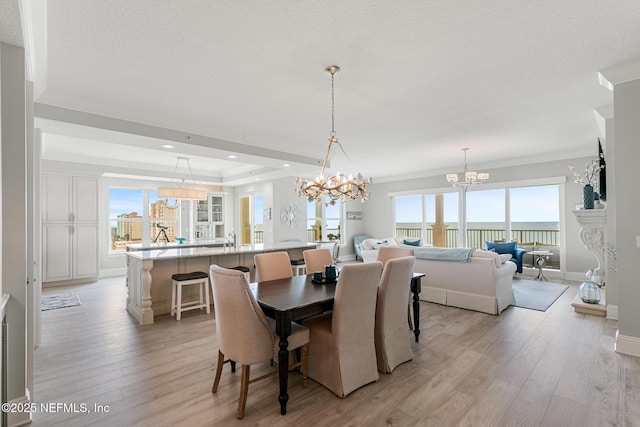 932 1st St N Unit 902, Jacksonville Beach, FL 32250 - dining area with a chandelier, light wood-style flooring, recessed lighting, baseboards, and ornamental molding