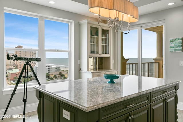 932 1st St N Unit 902, Jacksonville Beach, FL 32250 - kitchen with green cabinetry, healthy amount of natural light, a water view, baseboards, and recessed lighting