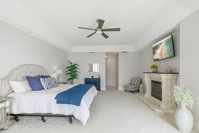 932 1st St N Unit 902, Jacksonville Beach, FL 32250 - carpeted bedroom featuring a fireplace, ceiling fan, baseboards, and a tray ceiling