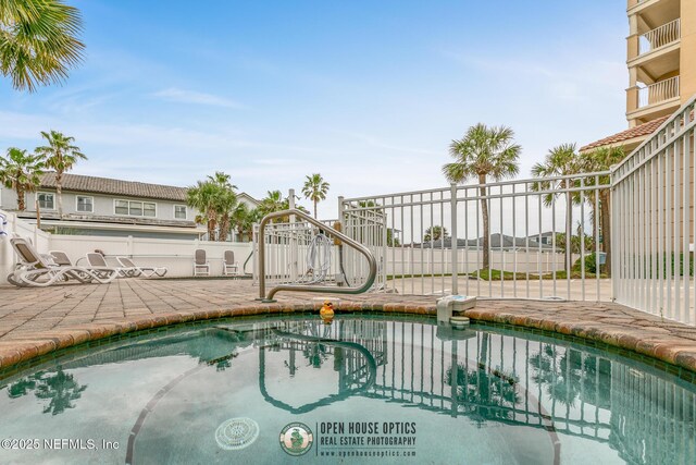 932 1st St N Unit 902, Jacksonville Beach, FL 32250 - view of swimming pool with a patio and fence