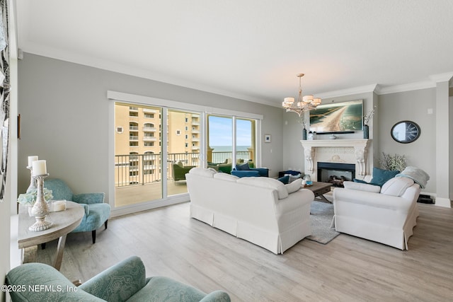 932 1st St N Unit 902, Jacksonville Beach, FL 32250 - living area with crown molding, a chandelier, light wood finished floors, a fireplace, and baseboards
