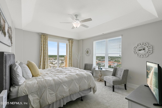 932 1st St N Unit 902, Jacksonville Beach, FL 32250 - bedroom featuring a tray ceiling, carpet flooring, baseboards, and a ceiling fan