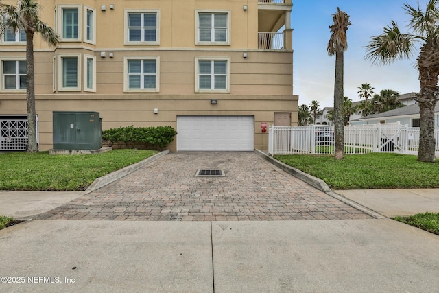 932 1st St N Unit 902, Jacksonville Beach, FL 32250 - view of front of property featuring decorative driveway, an attached garage, and stucco siding