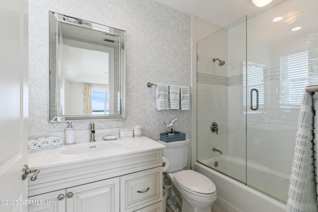 932 1st St N Unit 902, Jacksonville Beach, FL 32250 - bathroom with wallpapered walls, bath / shower combo with glass door, vanity, and toilet